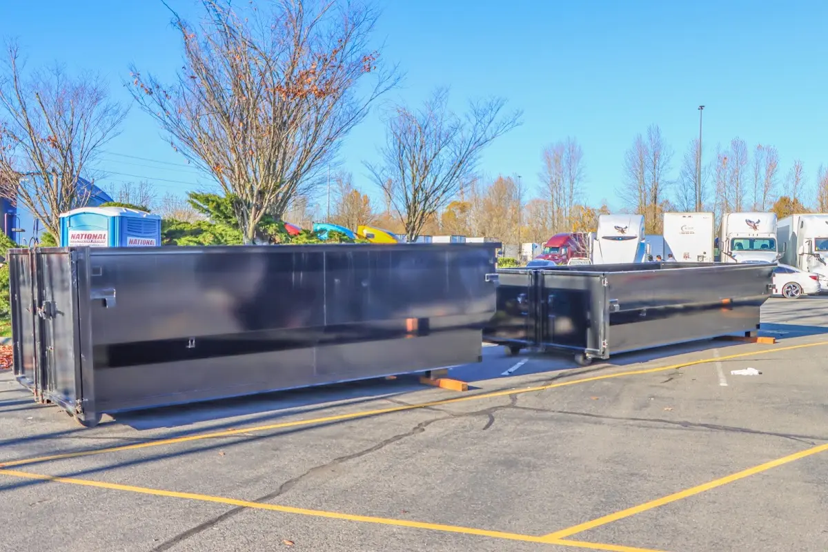 Professional dumpster rental service with roll-off container on residential driveway in Parker